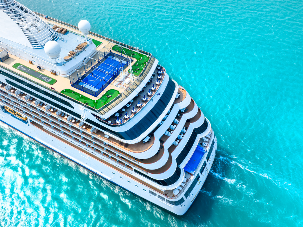 Cruise ship from above on green clear ocean