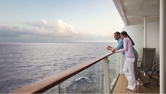 Couple on a cruise looking out across the water