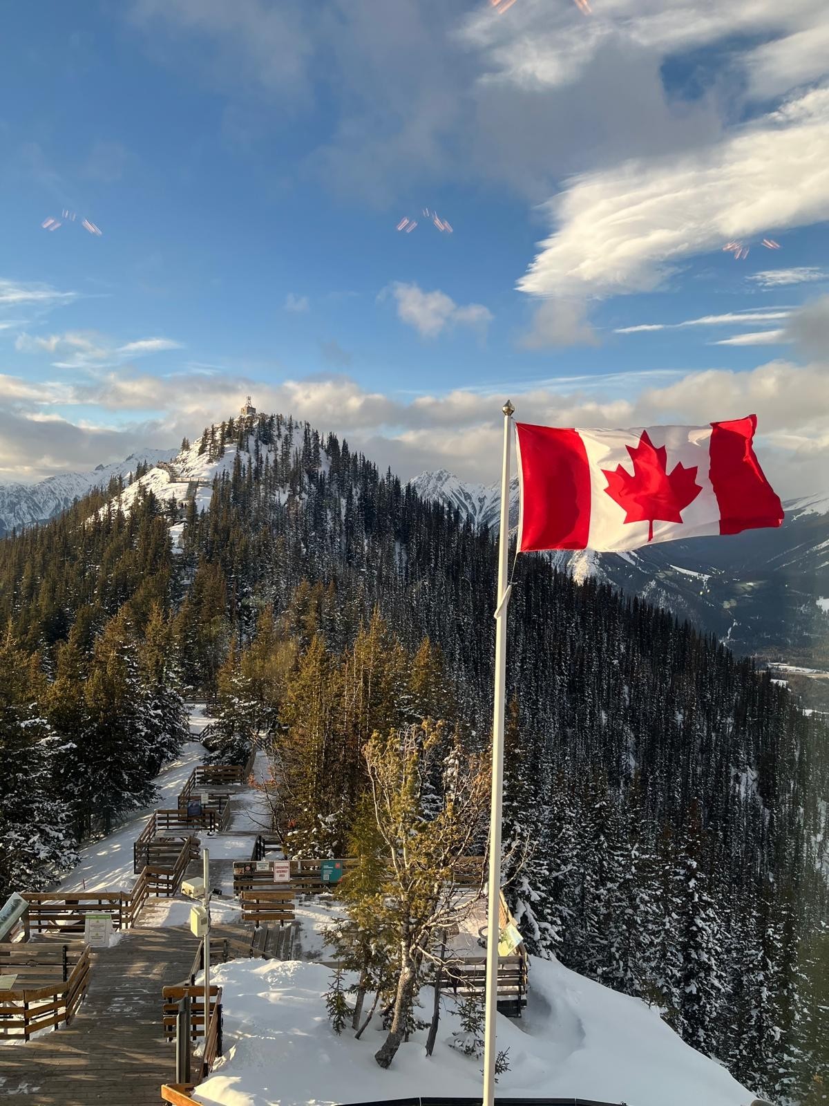 Canadian flag by a mountain