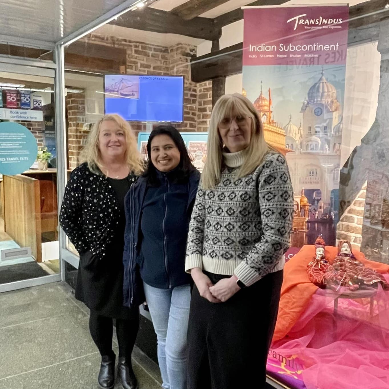 Two of the Peakes team with an operator from TransIndus standing in the Peakes Travel Elite entrance