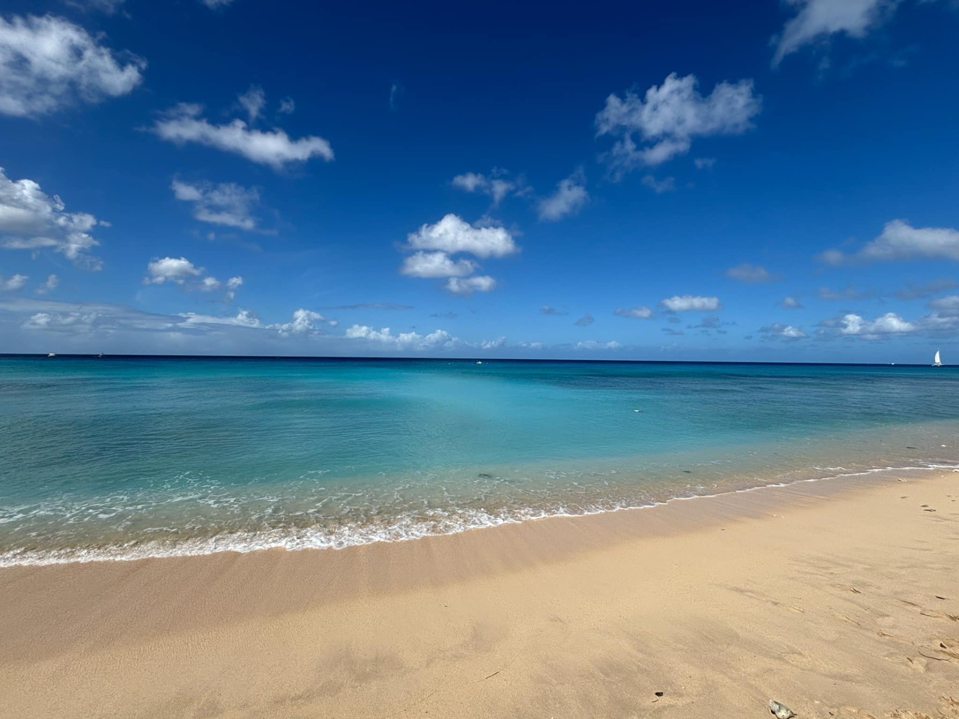 A white sandy beach with a clear sea beyond it