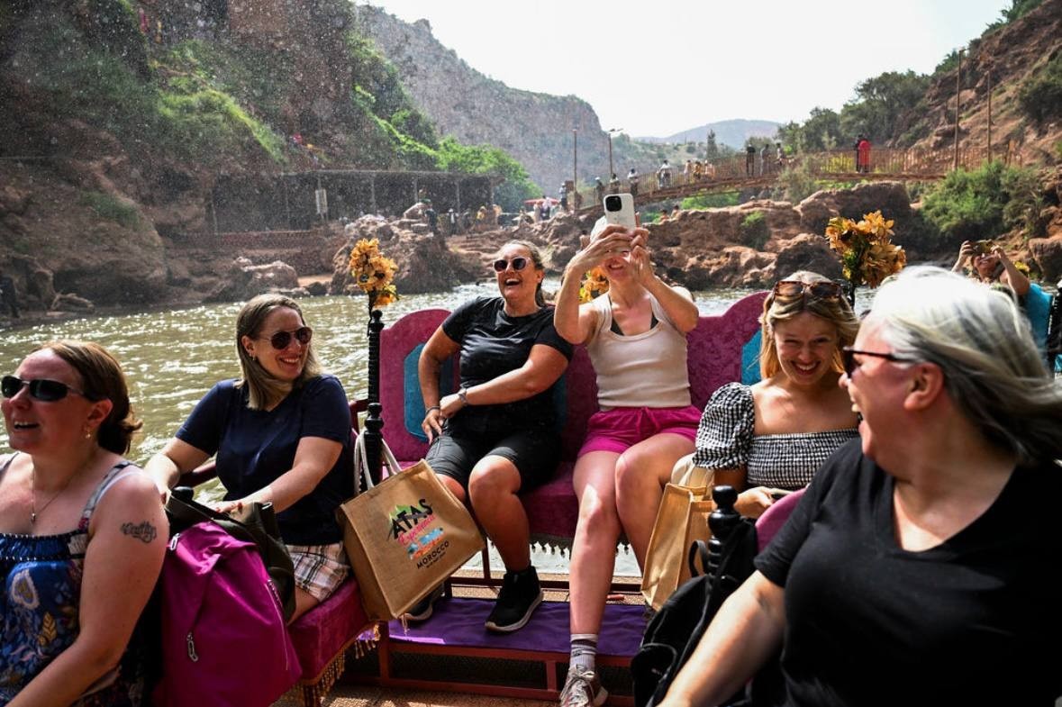 The group in the boat, all smiling and laughing