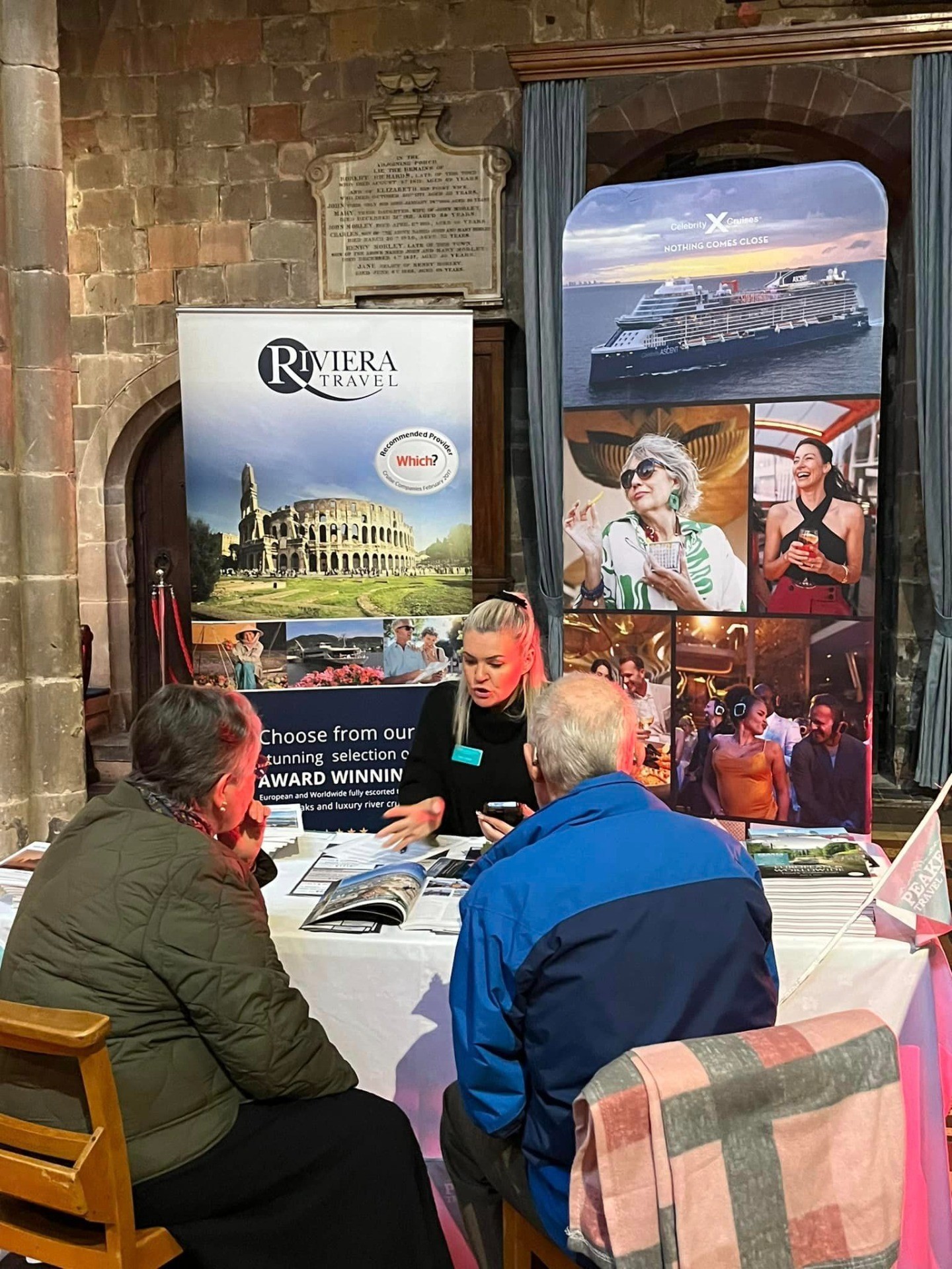 A travel expert speaks to two customers